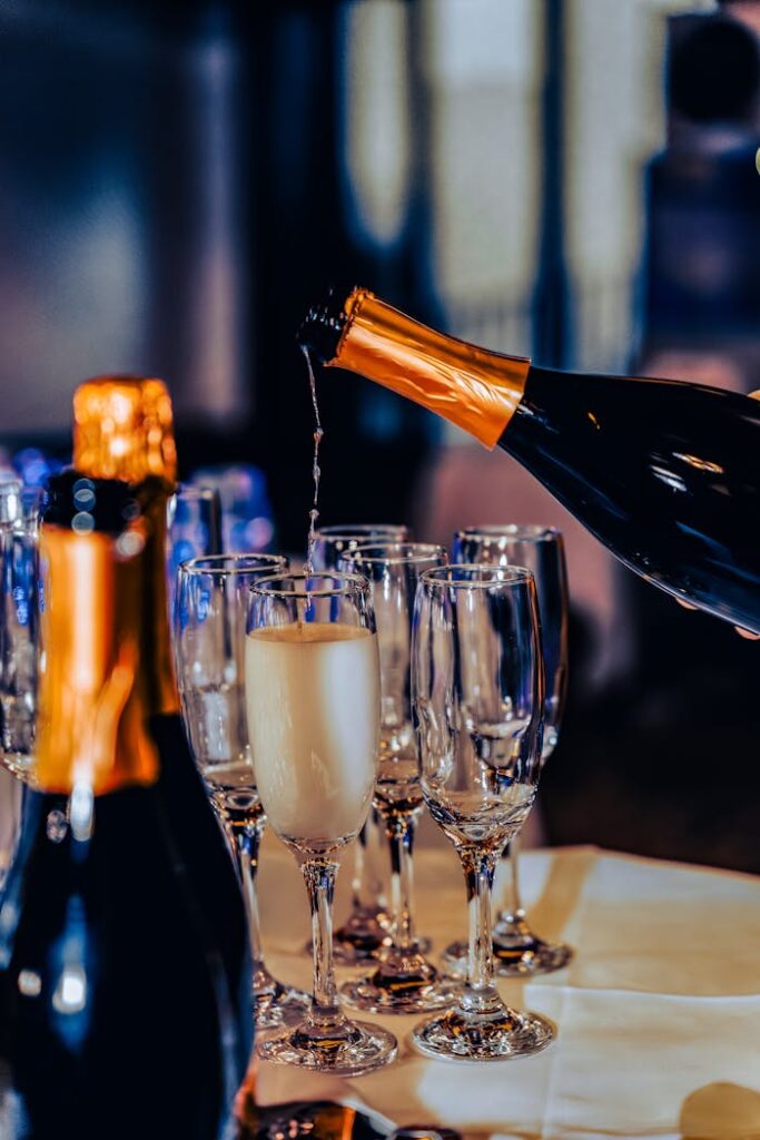 Luxurious champagne being poured into flute glasses at a festive gathering.